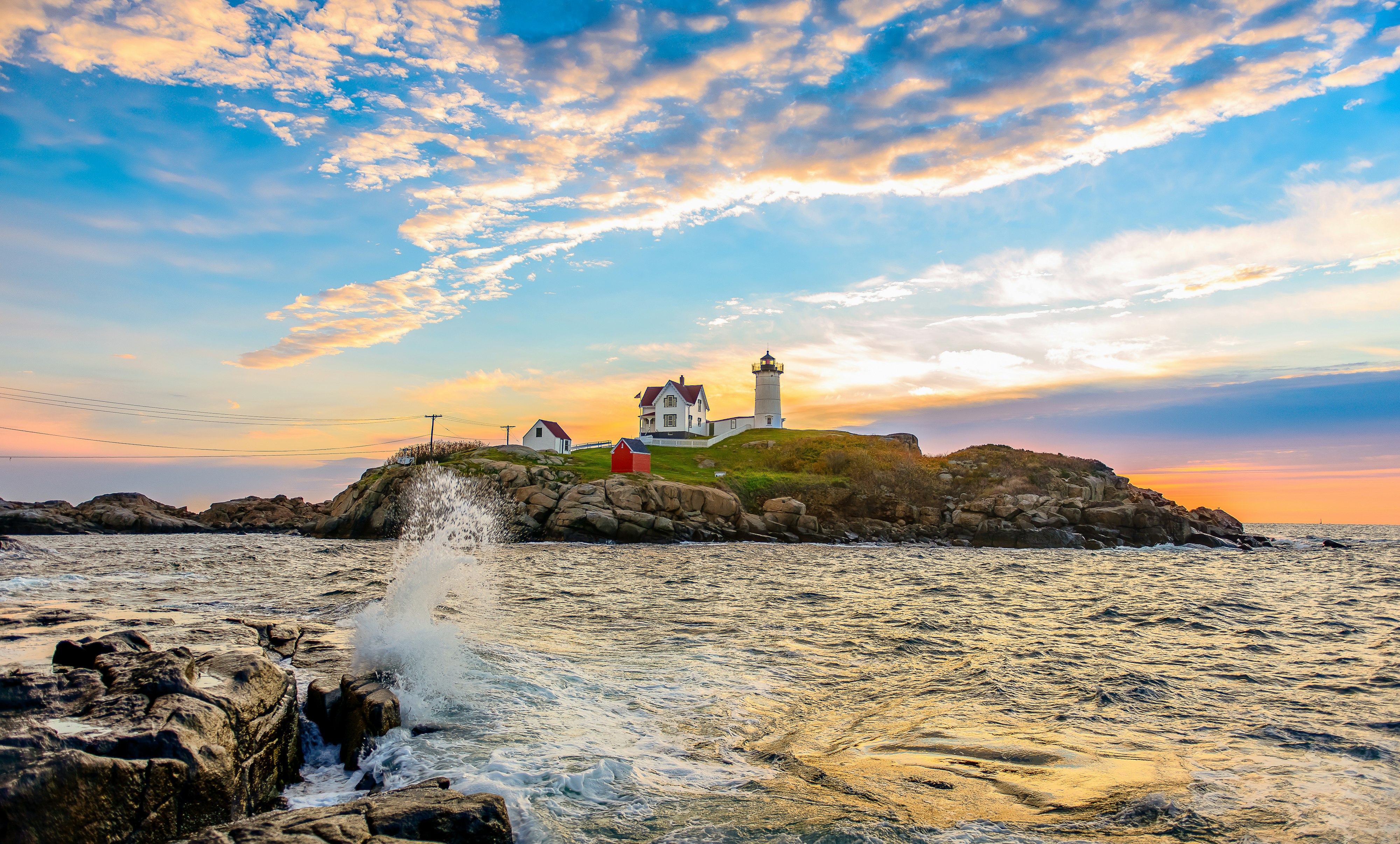 white lighthouse near body of water under blue sky during daytime